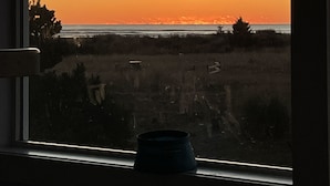 A view from a window overlooking a beach at sunset. - Ocean Views, Beach Path, Private + Pickleball + Nature Baths (Grayland)
