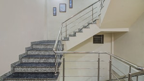 A staircase with granite steps and metal railings. - Treebo Royal, Chandrapur (Chandrapur)