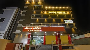 A hotel with a sign reading "ROYAL HOTEL & RESTAURANT" and another sign in a different language. - Treebo Royal, Chandrapur (Chandrapur)