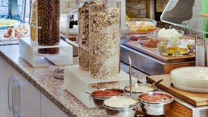A buffet with various food items and condiments. - Adeba Plus (Prague)