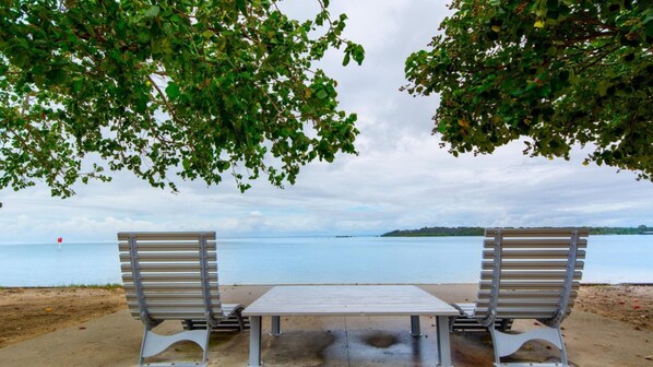 Guests can sit on the benches overlooking the calm body of water.