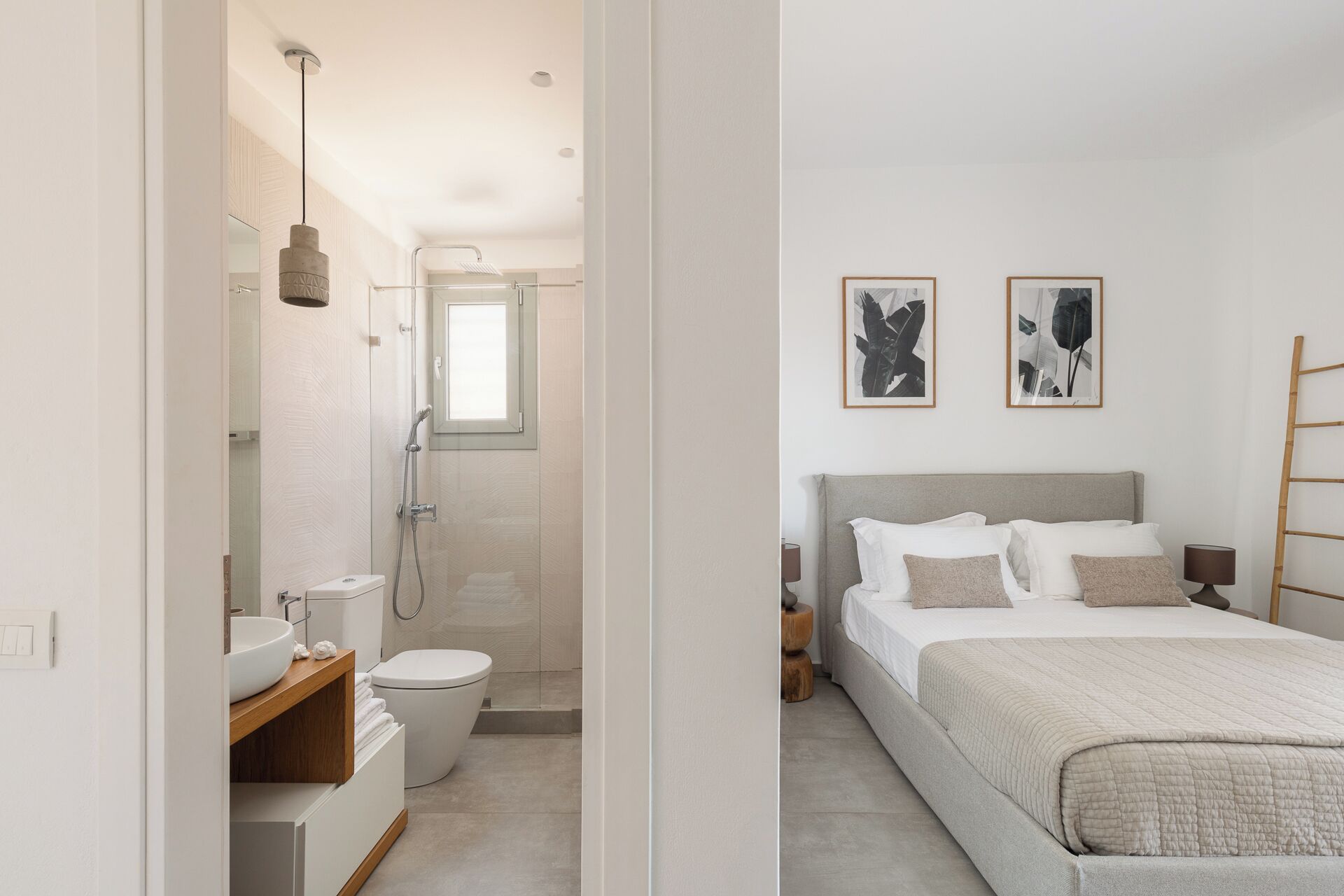 A modern bathroom with a shower, toilet, and sink.