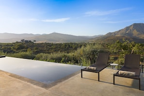 Outdoor pool, open 9:00 AM to 8:00 PM, pool umbrellas, pool loungers