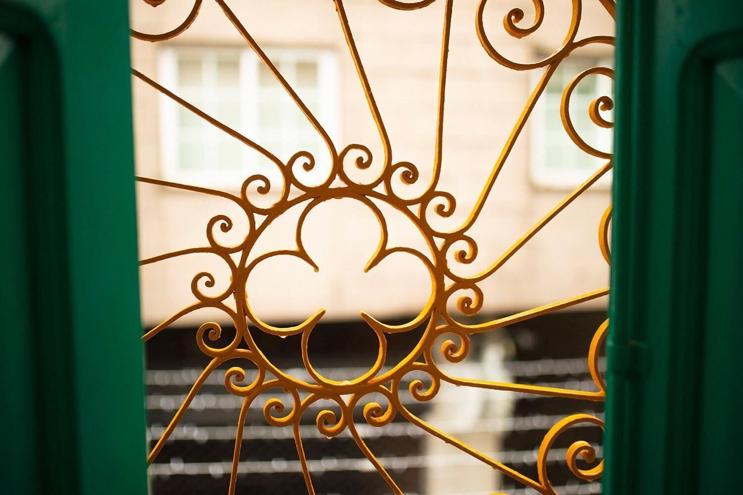 A wrought iron gate with intricate designs.