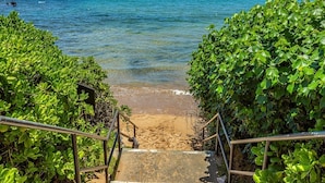 A staircase leading to a beach with clear blue water and a mountain in the background. - Wailea Ekahi Two Bedrooms - Ocean View by Coldwell Banker Island Vacations (Kihei)