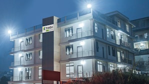 A multi-story hotel with a prominent 'treebo' sign, balconies, and large windows. - Treebo Staying Center (Shillong)