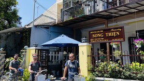A building with a sign for 'Homestay' and a balcony with potted plants. - Homestay Song Thien (Da Nang)