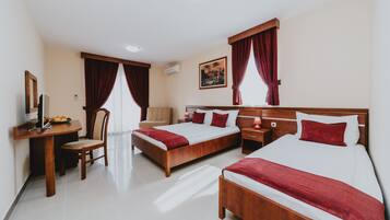 Deluxe Quadruple Room | Premium bedding, memory foam beds, desk, laptop workspace