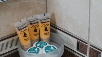 Shower, designer toiletries, hair dryer, towels