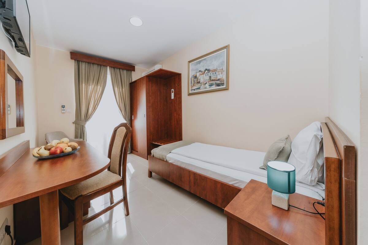 Deluxe Single Room | Living area | LCD TV