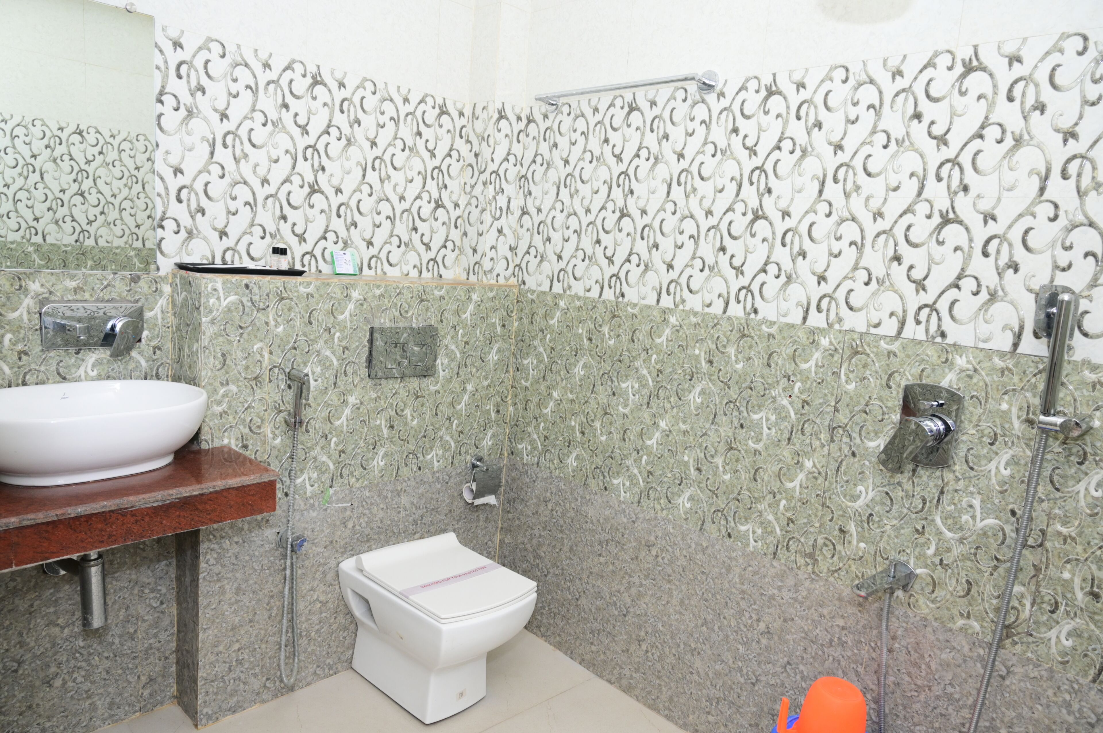 A bathroom with a white sink, a toilet, and a shower area.