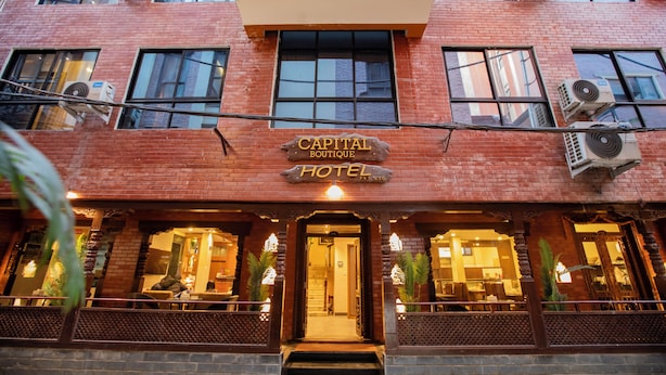 A hotel with a brick facade, multiple air conditioning units, and a sign reading "Capital Boutique Hotel". - Capital Boutique Hotel (Kathmandu)