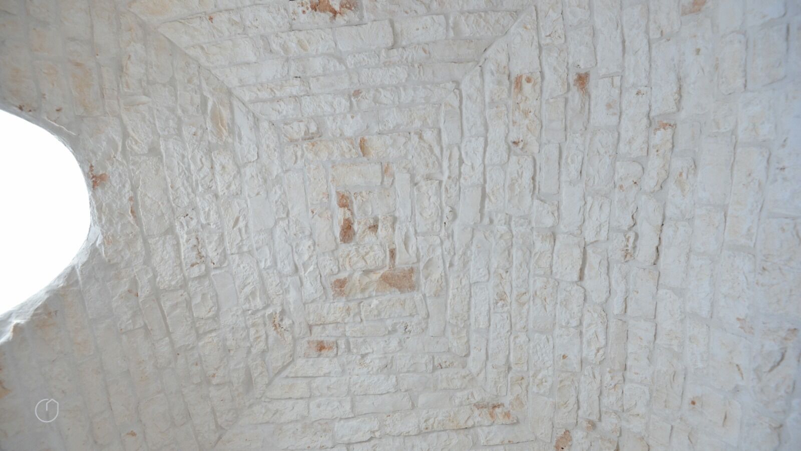 A white brick wall with a geometric pattern.
