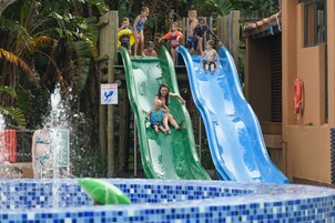 A water park with two slides and a pool area.