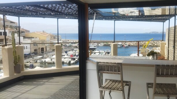 Un balcone con vista su un porto turistico e il mare.