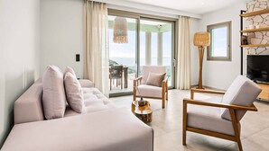A modern living room with a sofa, armchair, and a television. - Villa Ieros - Three Bedroom Villa, Sleeps 6 (Ionian Islands)