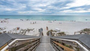 A beach with a wooden staircase leading down to the sand. - Sunsets You'll Never Forget- Private Patio/Hot Tub/Heated Pool (Miramar Beach)