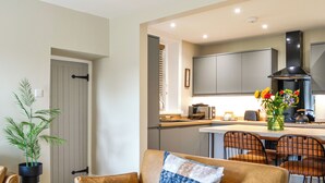 A modern kitchen with a built-in oven, microwave, and a large window. - Terraughtie Cottage West-UK43408 (Dumfries)