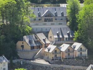 Traditional chalets blend seamlessly into the lush surroundings, offering scenic views from multiple levels and balconies.