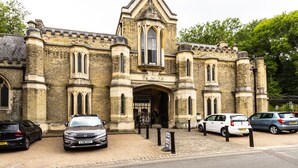 A historic building with a prominent entrance, large windows, and a brick facade. - Stylish one bedroom apartment in Greater London (London)