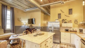 A compact living space with a kitchen, dining area, and a sofa. - Downtown Experience Rich in History & Charm! Centrally Located in Black Hills (Whitewood)