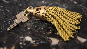 A key with a golden tassel and the number 208 on it.