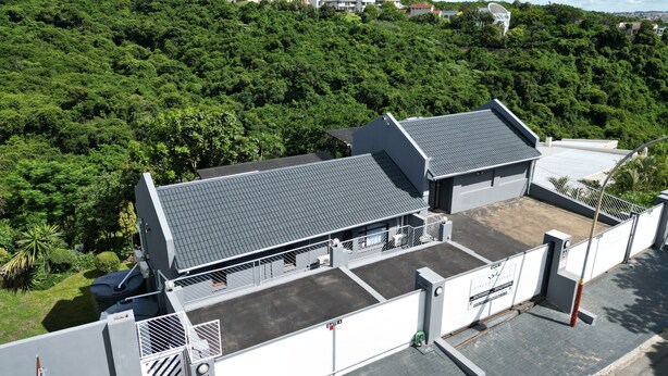 A building with a flat roof and a gated entrance.