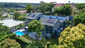 A modern two-story house with a swimming pool, solar panels, and a well-maintained garden. - Vincent Valley Lodge (East London)