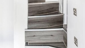 A staircase with dark wooden steps and white walls. - The Secret: Stylish and Spacious En Suite Bathroom (Blandford Forum)