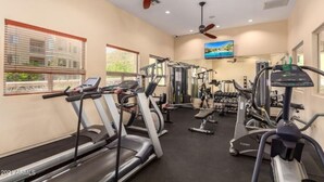 A gym with treadmills, elliptical machines, and weight equipment.