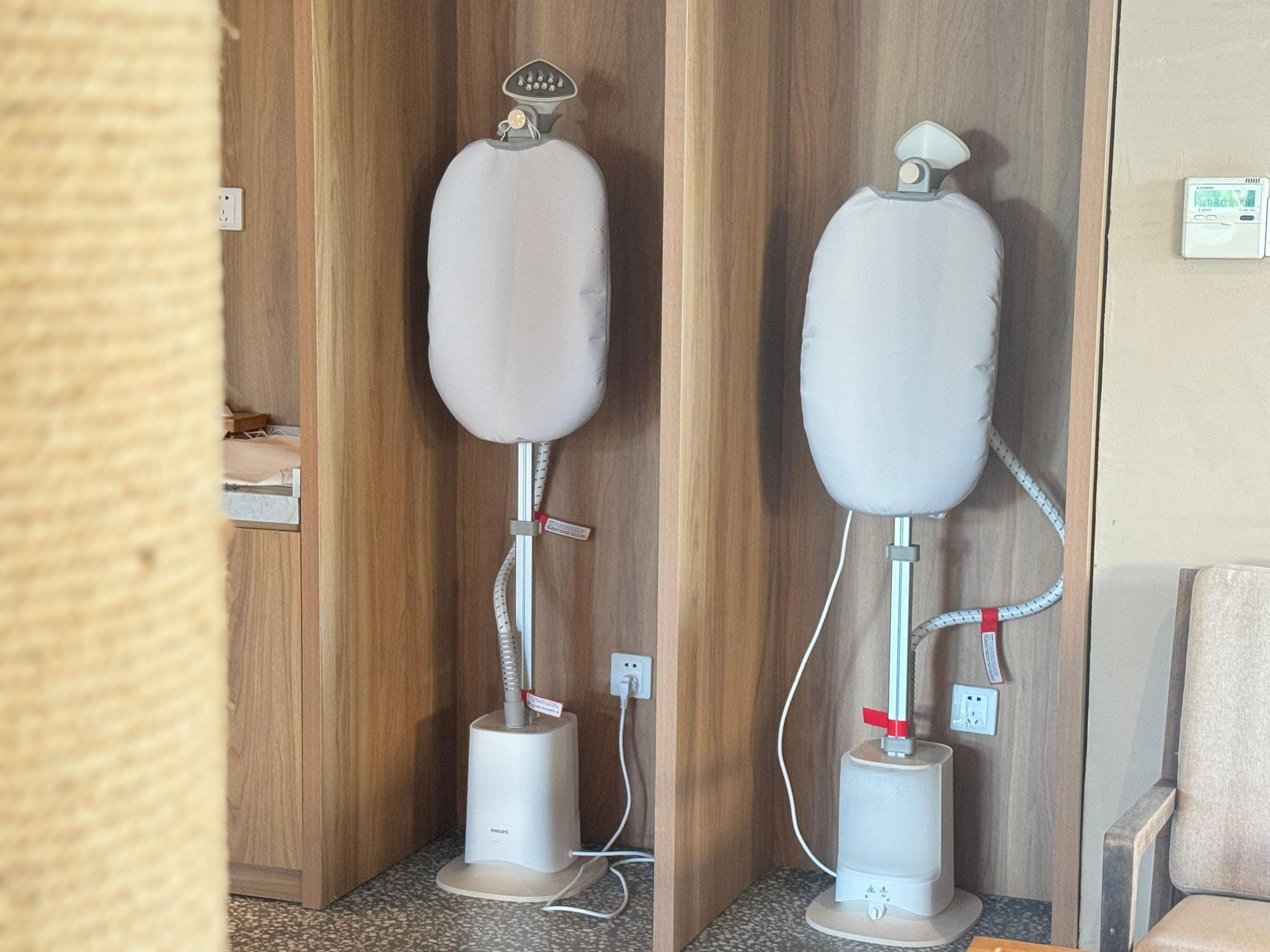Two white humidifiers in a wooden room with a tiled floor.