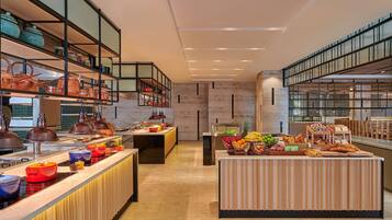 A modern kitchen with a central island, equipped with various cooking utensils and appliances.