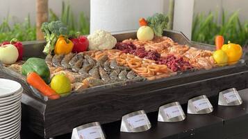 A buffet with various food items and labeled serving dishes.