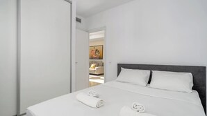 A hotel room with a bed, white linens, and a dark headboard. - Miraflores with pool by Costarentals - Ref 146 (Las Lagunas de Mijas)