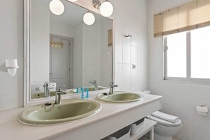 A modern bathroom with two sinks, a large mirror, and a window with blinds. - Townhouse with Pool by Costarentals- Ref 199 (Las Lagunas de Mijas)