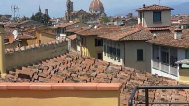 A rooftop terrace with a chair, a table, and a potted plant. - TERRACE VIEW FLORENCE ATTIC (Firenze)