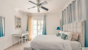 A bedroom with a bed, a desk, and a chair. - Huge Penthouse Near the Beach With Private Jacuzzi (Punta Cana)