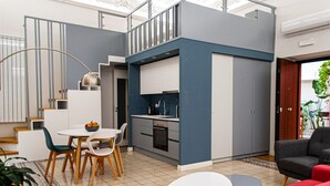 A modern apartment with a dining area, kitchen, and living space. - Opera Suites - Tosca (Palermo)