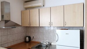 A kitchen with light wooden cabinets, a stainless steel sink, a white refrigerator, and a gas stove. - Apartment in Duće with Balcony, Air condition, WIFI (5146-7) (Duce)