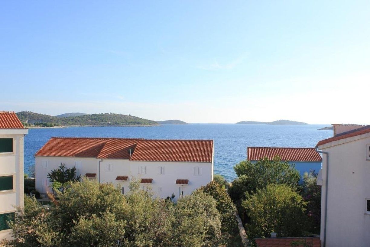 A coastal view with buildings and a sea.