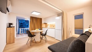 A compact living space with a kitchenette, a dining area, and a sofa. - Studio apartment in Mastrinka with Loggia, Air condition, WIFI (5159-2) (Mastrinka)