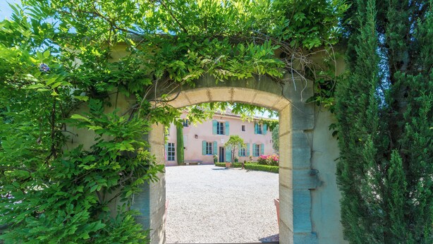 Un arc donnant sur une cour intérieure, avec un bâtiment en arrière-plan.