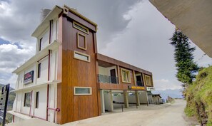 A hotel with a modern design, featuring a prominent tower section and a flat-roofed extension. - Treebo Down Town, Dalhousie (Dalhousie)