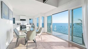 A modern kitchen with white cabinets and a built-in oven. - Black Swan Beachfront Home with Jacuzzi year round (Hampton Bays)