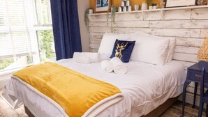 A neatly made bed with white linens, a yellow throw blanket, and decorative pillows. - James' Place @ The Park (Merthyr Tydfil)