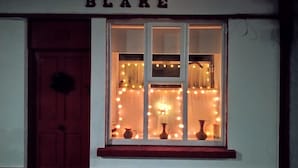 A building with a sign reading "BLAKE" above a window displaying three vases.