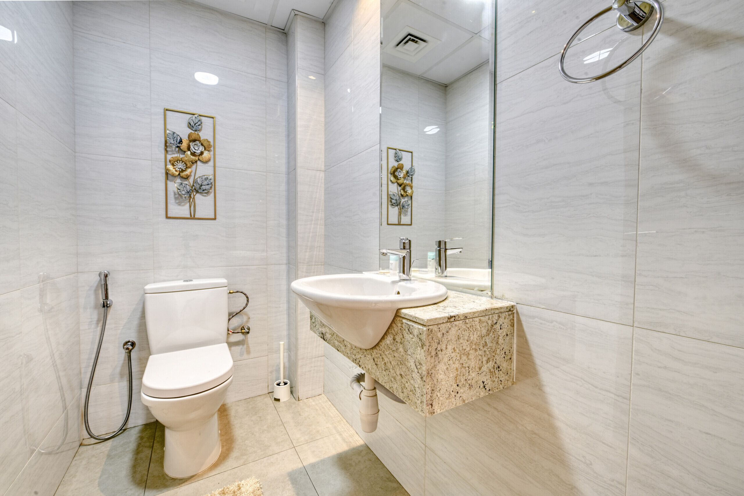 A modern bathroom with a toilet, sink, and shower.