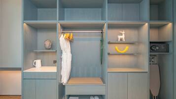 A modern closet with multiple compartments, including shelves for hanging clothes, a drying rack, and storage for shoes and toiletries.