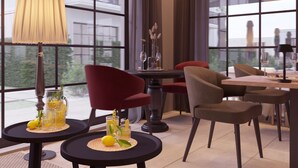 A modern dining area with a table set for two, a red chair, and a lamp. - Salento Winery Lodge (Manduria)