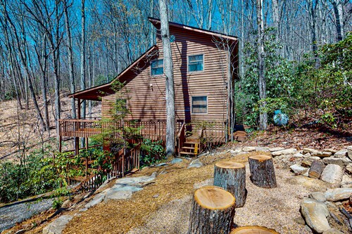 Mountain home nestled in the forest with a stream, deck, firepit, & game room